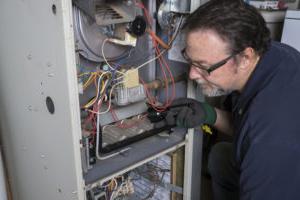 Our technician performing an annual furnace maintenance in Baton Rouge